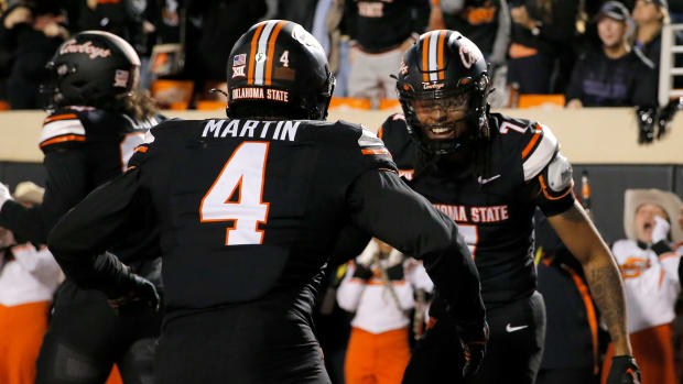 Oklahoma State's Cameron Epps (7) celebrates his interception with Nickolas Martin (4) in the first half of the college football game between the Oklahoma State University Cowboys and the Kansas State Wildcats at Boone Pickens Stadium in Stillwater. Okla., Friday, Oct. 6, 2023.